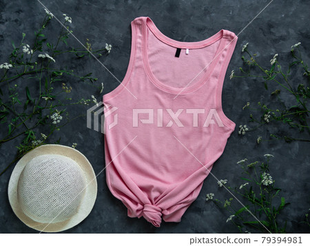Pink cotton tank top mockup on dark background Blank plain t-shirt template for creative design Female summer sunglasses Pink cotton tank top mockup on dark background Blank plain t-shirt template for creative design Female summer sunglasses 79394981