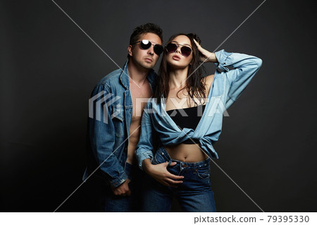 beautiful couple wearing trendy glasses and posing together. Hipster boy and wet hair 79395330