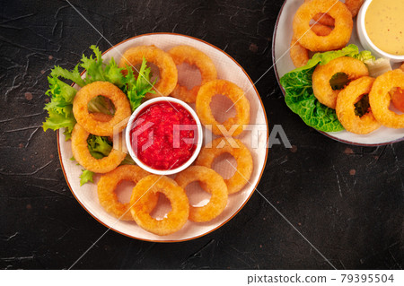 Calamari rings. Deep fried squid rings with various dips, overhead flat lay shot 79395504