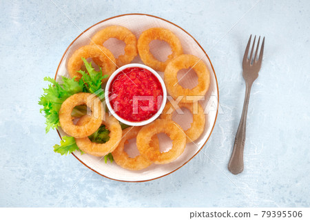 Calamari rings plate. Deep fried squid rings with ketchup and green salad leaves 79395506