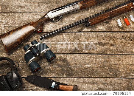 Hunting equipment on old wooden background including rifle, knife, binoculars and cartridges Hunting equipment on old wooden background including rifle, knife, binoculars and cartridges 79396134