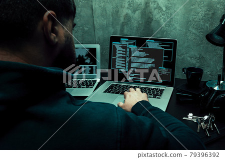Close up of programmer of hacker hands typing a code 79396392