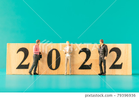 Miniature people : Business people standing on wooden block number 2022 79396936