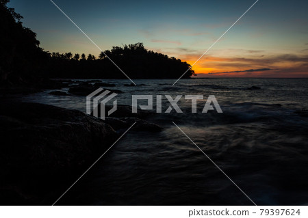 Vivid sunset sky waterscape and silhouette forest island Vivid sunset sky waterscape and silhouette forest island 79397624