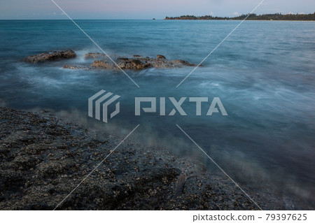 Waves and rocks shore long exposure Waves and rocks shore long exposure 79397625