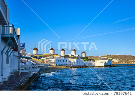 Beautiful view of famous traditional white windmills on hill top, Mykonos, Greece. Whitewashed houses, summer, morning, sea, iconic destination Beautiful view of famous traditional white windmills on hill top, Mykonos, Greece. Whitewashed houses, summer, morning, sea, iconic destination 79397641