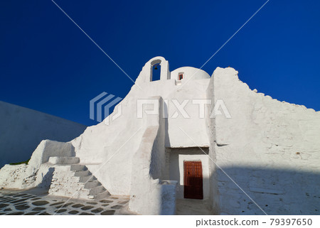 Famous tourist landmark, Mykonos, Greece. White Greek Orthodox church of Panagia Paraportiani, town of Chora on island at sunrise. Iconic destination Famous tourist landmark, Mykonos, Greece. White Greek Orthodox church of Panagia Paraportiani, town of Chora on island at sunrise. Iconic destination 79397650