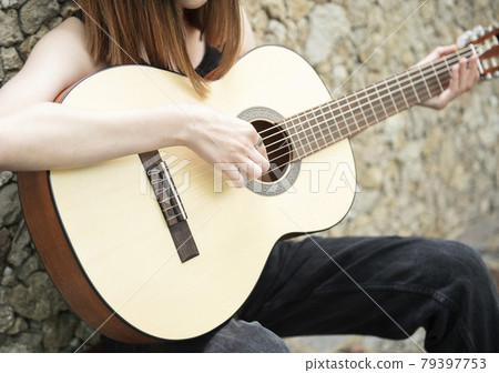 Teenage girl with a guitar Teenage girl with a guitar 79397753