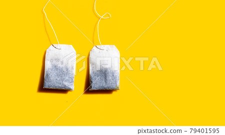 Tea bags on yellow background. Tea bags on yellow background. 79401595