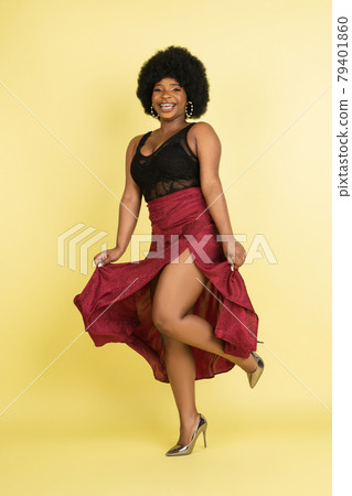 Portrait of African young woman isolated over light yellow studio background. Concept of human emotions, facial expression, youth, sales, ad. 79401860