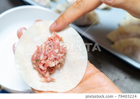 A photo of making dumplings. A photo of handmade dumplings. A photo of making dumplings. A photo of handmade dumplings. 79403224
