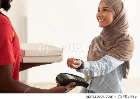 Black deliveryman holding pizza boxes and pos terminal Black deliveryman holding pizza boxes and pos terminal 79405459