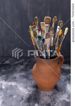 Paint brush in clay jug on abstract table background . Paintbrush for painting art still life 79405669