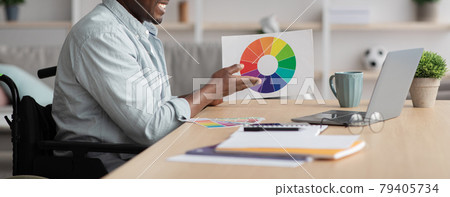 Creative male in workplace. Designer working with color palette at office desk, choosing color samples for project 79405734