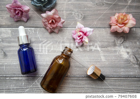 bottles with a dropper of hyaluronic serum and cosmetic containers for beauty procedures on a wooden background with flowers. beauty and skin care bottles with a dropper of hyaluronic serum and cosmetic containers for beauty procedures on a wooden background with flowers. beauty and skin care 79407608