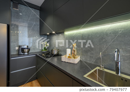 Modern large luxury dark gray kitchen closeup Modern large luxury dark gray kitchen closeup 79407977