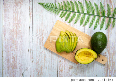healthy eat and lifestyle with avocado slice on wooden board healthy eat and lifestyle with avocado slice on wooden board 79412163