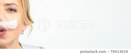 Funny beautician with a white feather-like mustache poses on white background, depilation concept. Funny beautician with a white feather-like mustache poses on white background, depilation concept. 79413639