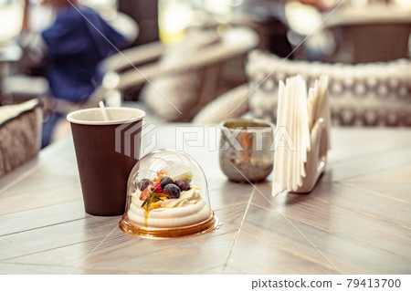 Chocolate multilayer cake or piece of cake on an eco-friendly paper plate in a street cafe 79413700