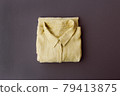 a neatly folded yellow shirt 79413875