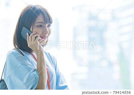 拜訪她的智能手機的年輕女商人 拜訪她的智能手機的年輕女商人 79414856