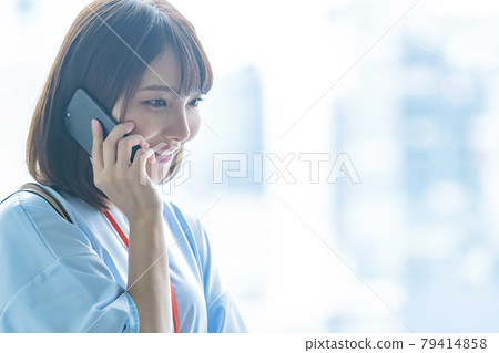 Young business woman calling on her smartphone Young business woman calling on her smartphone 79414858