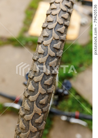 Bike waiting mechanic for repair in bicycle repair shop, outdoor. Bicycle wheel close up ready for examines, fixes modern cycle transmission system. Bike maintenance, sport shop concept. Bike waiting mechanic for repair in bicycle repair shop, outdoor. Bicycle wheel close up ready for examines, fixes modern cycle transmission system. Bike maintenance, sport shop concept. 79420536