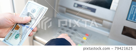 Man withdrawing american dollars from ATM closeup Man withdrawing american dollars from ATM closeup 79421625