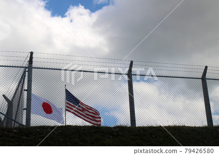 Japanese flag and Star-Spangled Banner seen through the fence Japanese flag and Star-Spangled Banner seen through the fence 79426580