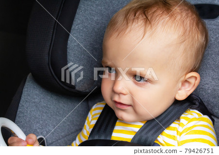 Caucasian baby boy sitting in car seat. Caucasian baby boy sitting in car seat. 79426751