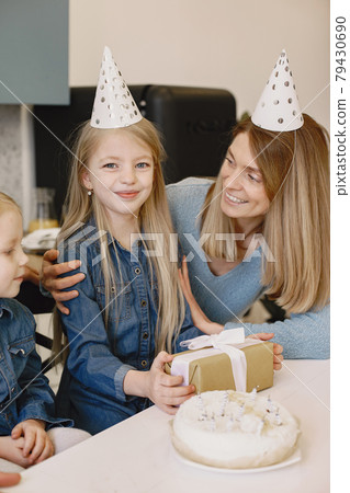 Family celebrating birthday in the kitchen 79430690