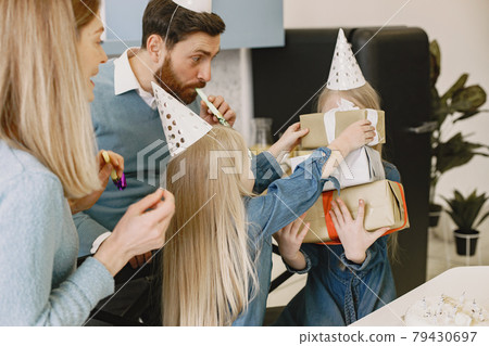 Family celebrating birthday in the kitchen 79430697