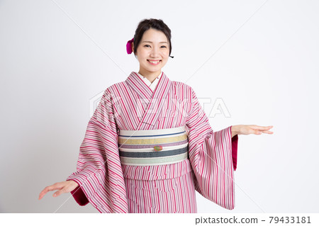 A young Japanese woman wearing a small crest and posing A young Japanese woman wearing a small crest and posing 79433181