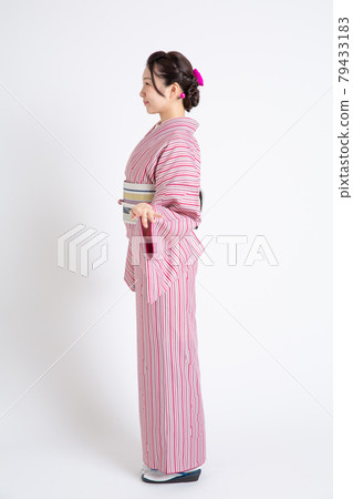 A young Japanese woman wearing a small crest and posing A young Japanese woman wearing a small crest and posing 79433183