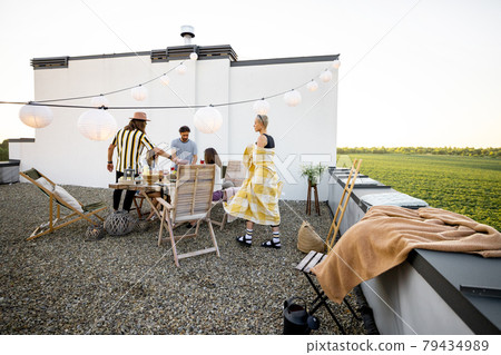 Friends chilling on the roof terrace 79434989