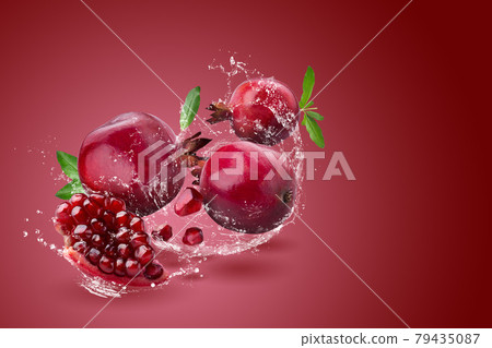 Ripe pomegranate fruit on red background. Ripe pomegranate fruit on red background. 79435087