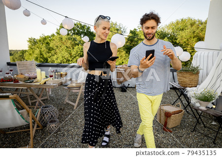 Two friends hanging out at picnic outdoors Two friends hanging out at picnic outdoors 79435135