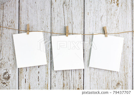 Blank polaroid notepad hanging on the wall Blank polaroid notepad hanging on the wall 79437707