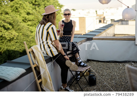 Two friends hanging out at picnic outdoors 79438289