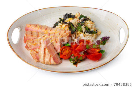 Grilled pork chop and rice with sauce 79438395