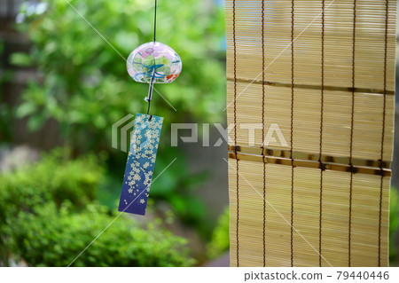 A swaying wind chime in a Japanese-style garden A swaying wind chime in a Japanese-style garden 79440446