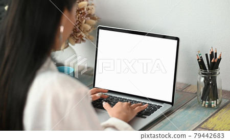 Cropped shot of young Asian businesswoman working on computer laptop in her workplace. Cropped shot of young Asian businesswoman working on computer laptop in her workplace. 79442683