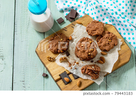 Baked christmas cookies. Homemade Chocolate chip cookies and milk on a wooden rustic table. Copy space. 79443183