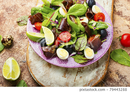 Delicious salad with vegetables, herbs and ham 79443288