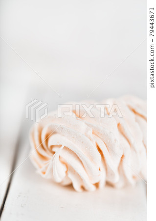 Appetizing white zephyr on a wooden table. Tea drinking concept. Confectionery decoration. Place for text Appetizing white zephyr on a wooden table. Tea drinking concept. Confectionery decoration. Place for text 79443671