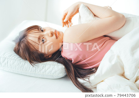 Woman lying in bed Woman lying in bed 79443706