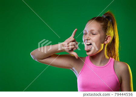 teenager girl shouting doing rock symbol with hands up 79444556