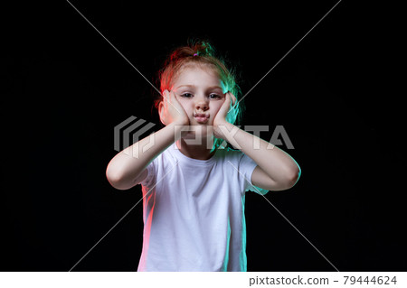 cute redhead little child girl on black background. 79444624