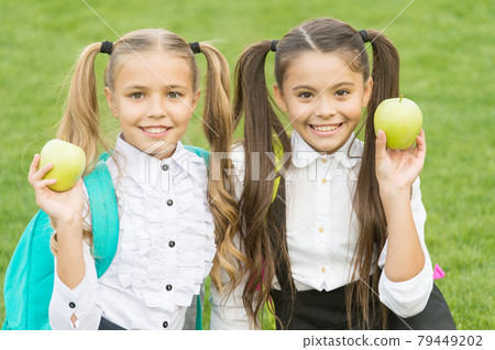 Break for snack. Happy children hold green apples outdoors. Break for snack. Happy children hold green apples outdoors. 79449202