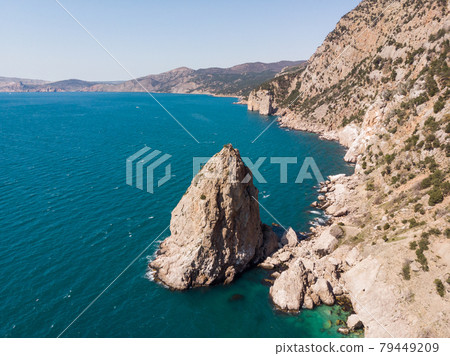 Rocky coast from a bird's eye view. Rocks and sea stretching over the horizon. Rocky coast from a bird's eye view. Rocks and sea stretching over the horizon. 79449209